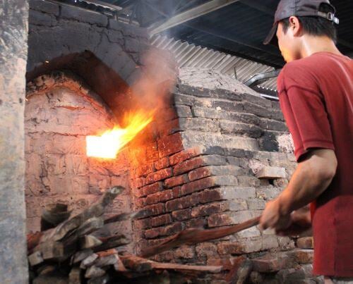 Adding Wood to the Kiln